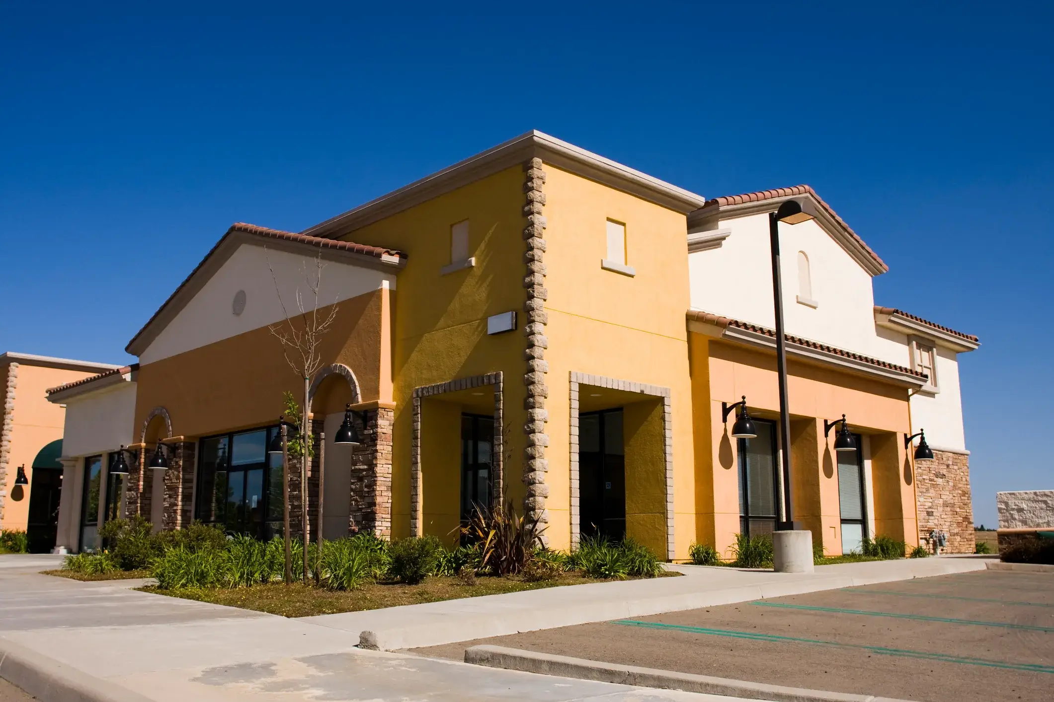 A stucco and stone business building with a freshly painted exterior